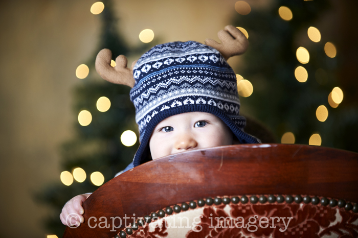 peek-a-boo baby boy in reindeer hat
