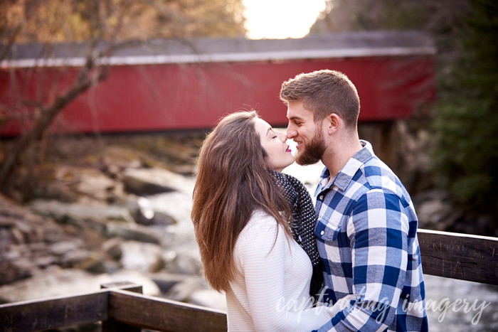 kissing by the covered bridge