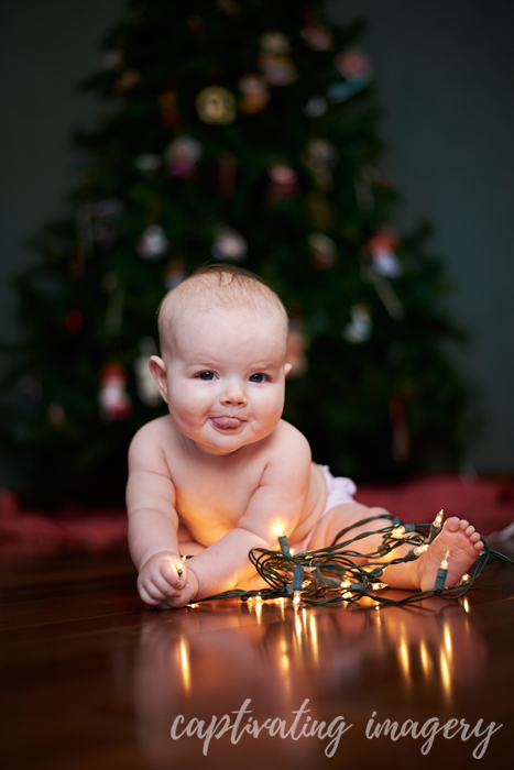 baby with Christmas lights