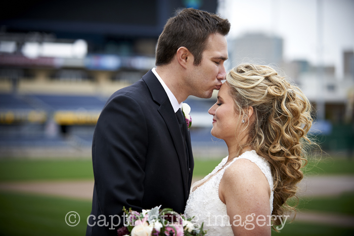 bride and groom on the field at PNC