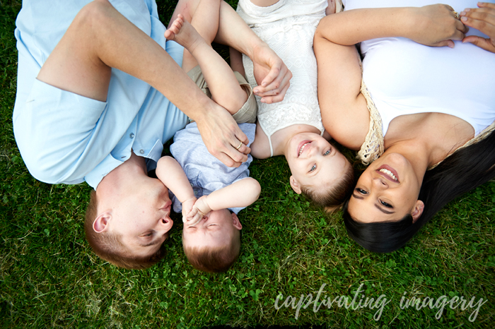 family portrait laying in the grass