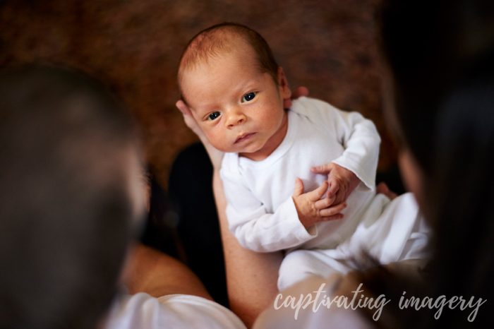 baby looking up at his parents