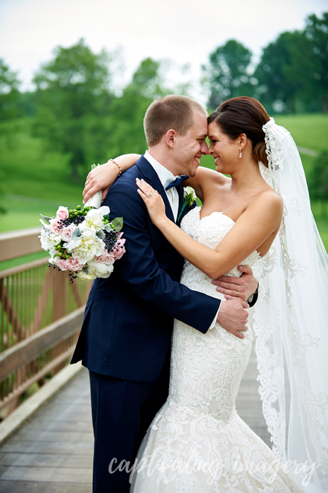 bride and groom on bridge