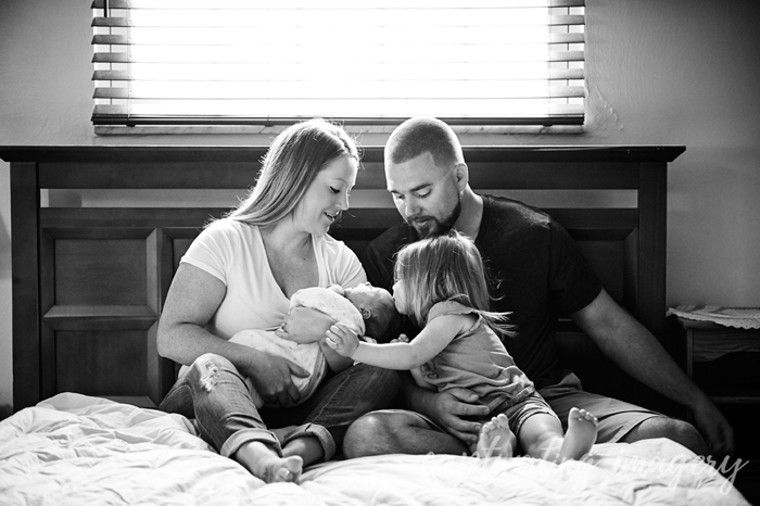 big sister kissing the baby