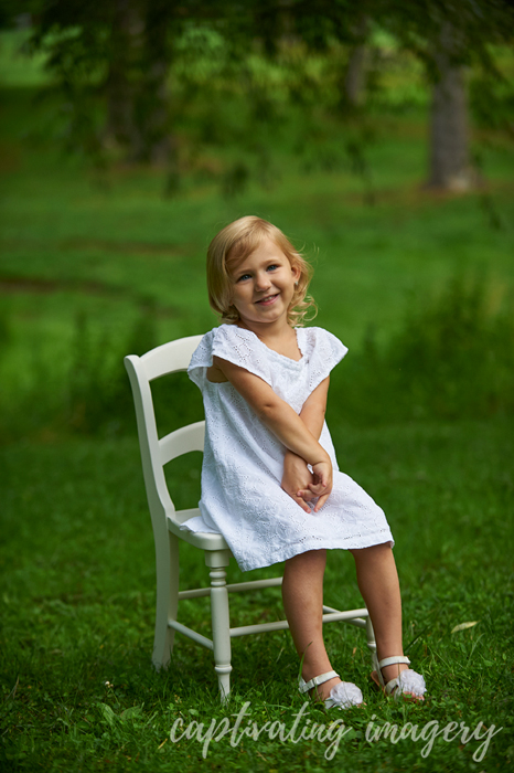 little girl sitting pretty on a chair