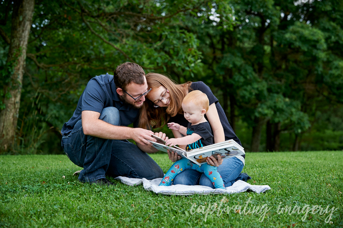 mom and dad reading to their daughter