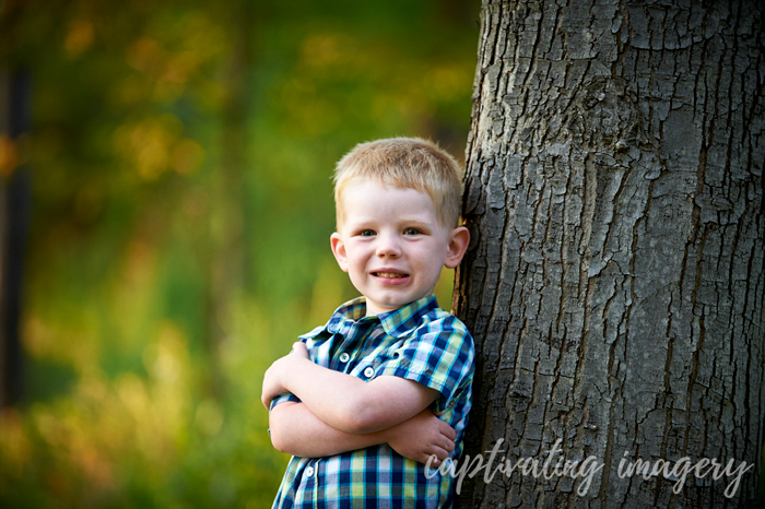 cool dude leaning on a tree