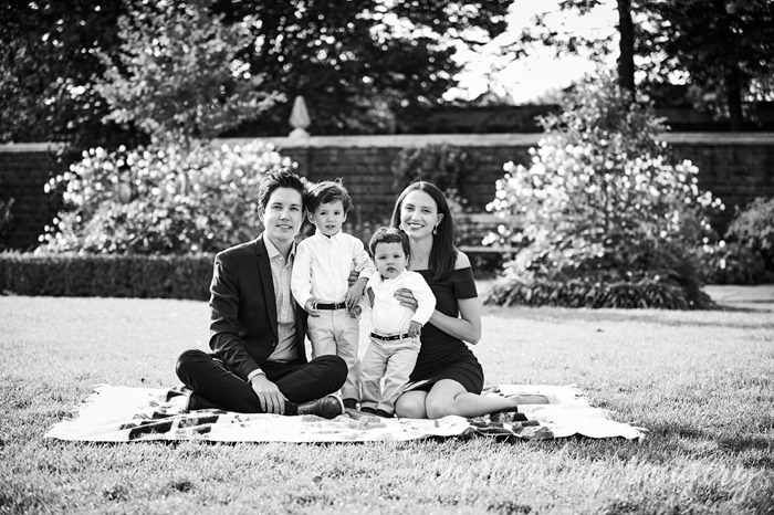 family seated on a blanket