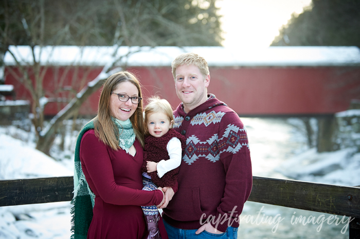 family portrait in front of the covered bridge