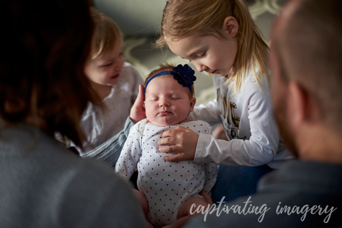 adoring their baby sister