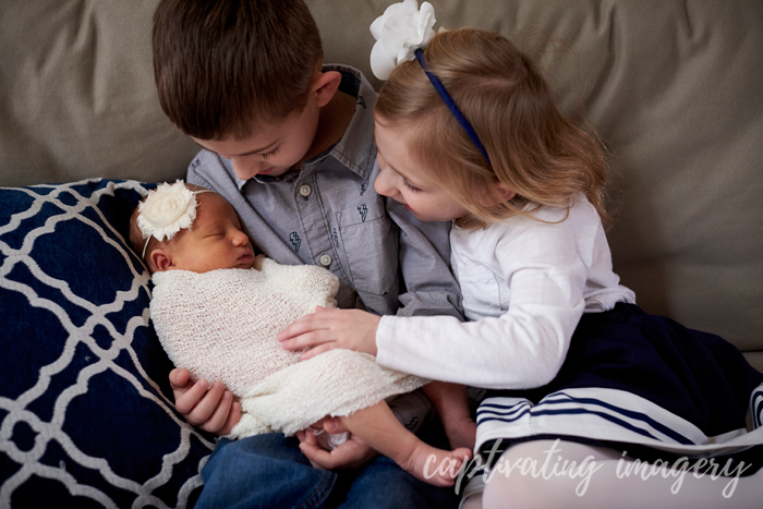 big brother holds baby sister