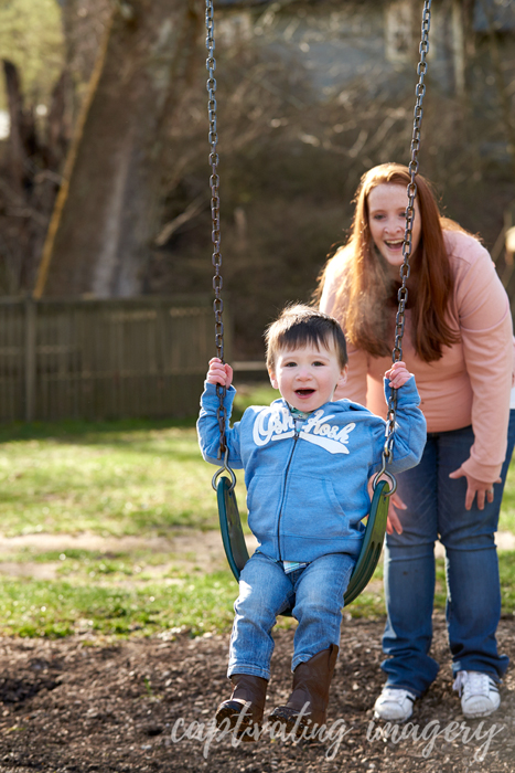 mommy pushing son on swings