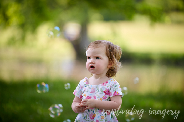 little girl watching bubbles