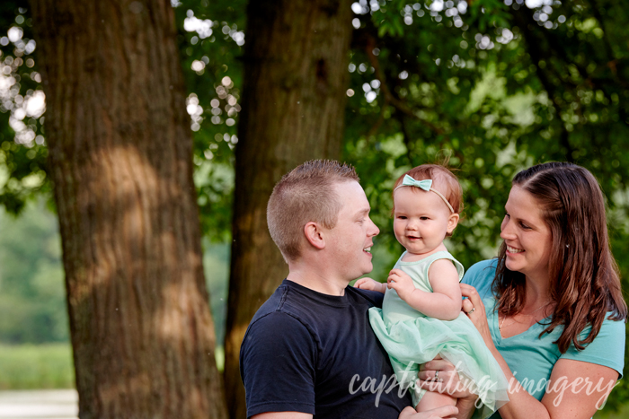 dad, mom, and daughter sharing some laughs