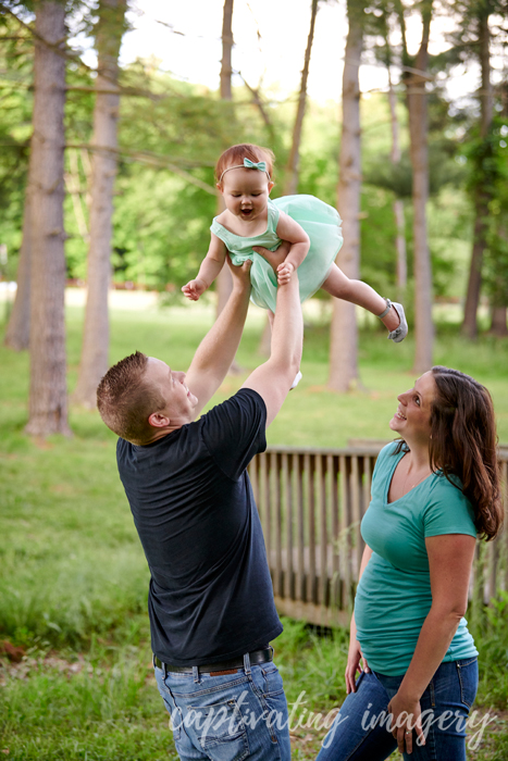 dad tossing his daughter in the air