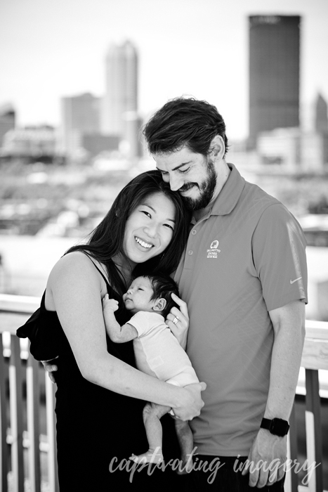 baby snuggles with mom and dad