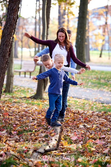 family balancing on a log