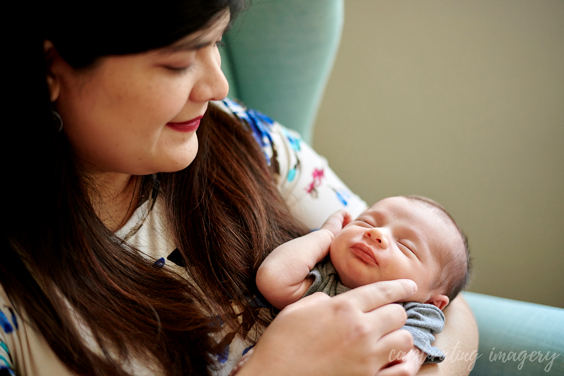 mother holds sleeping baby