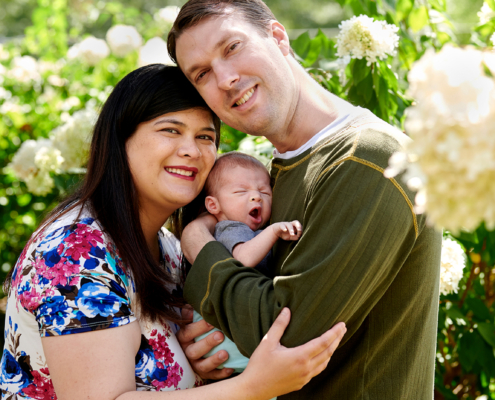 mother and father hold baby