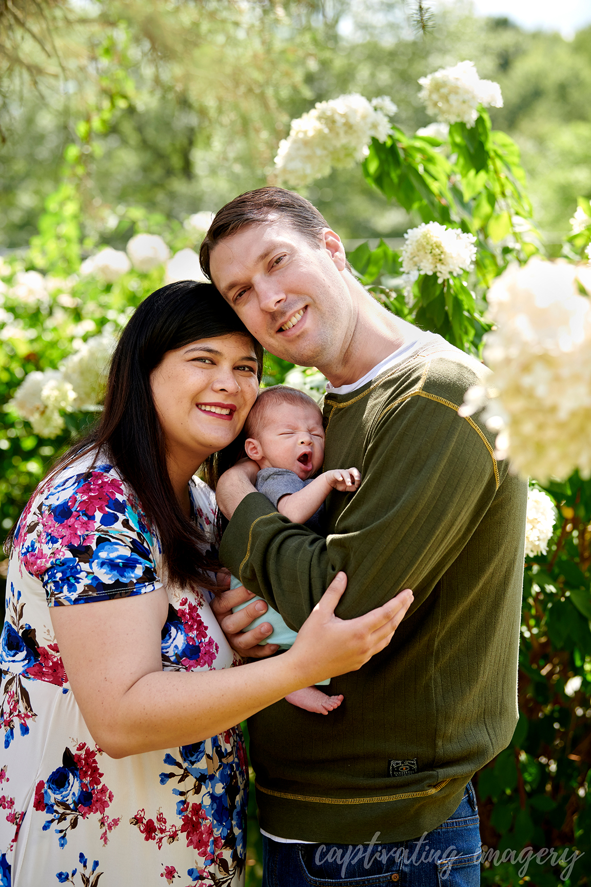 mother and father hold baby