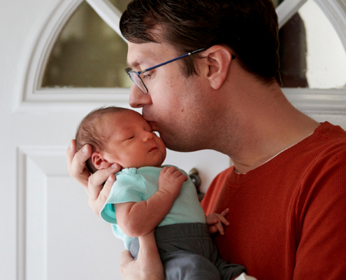 father holding baby