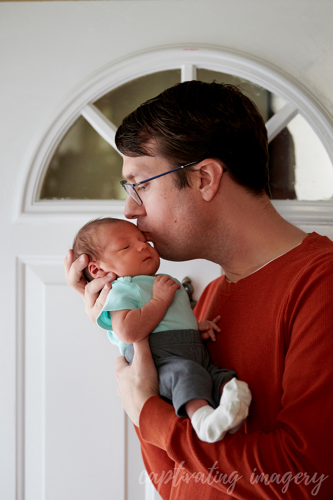 father holding baby