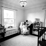 mother, father, and baby together in nursery