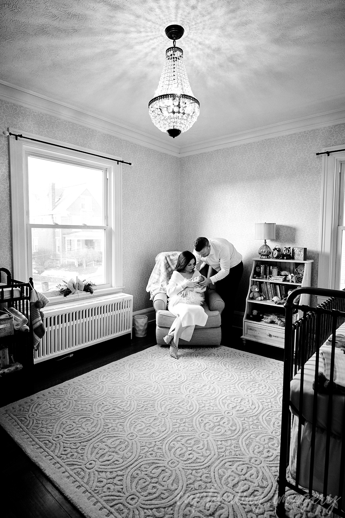 mother, father, and baby together in nursery