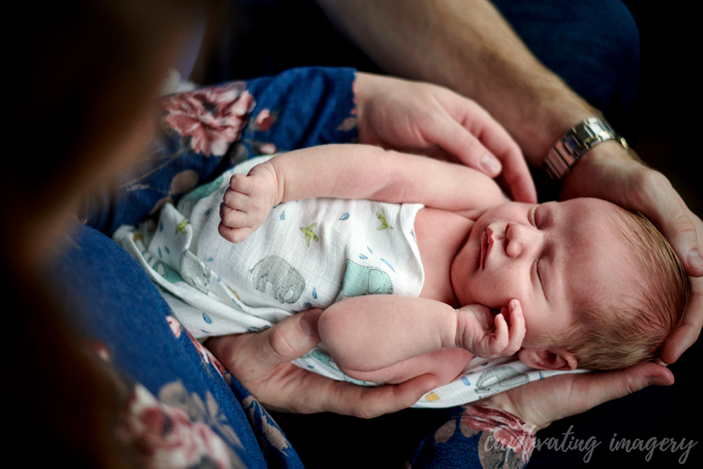 sleeping baby being held