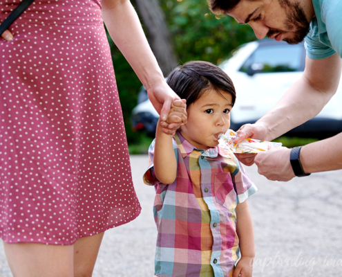 dad feeds toddler applesauce