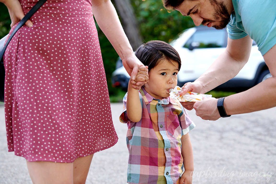 dad feeds toddler applesauce