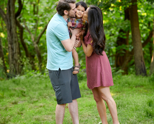 parents kiss toddler face