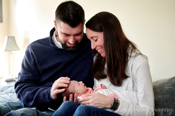 mom and dad hold baby color