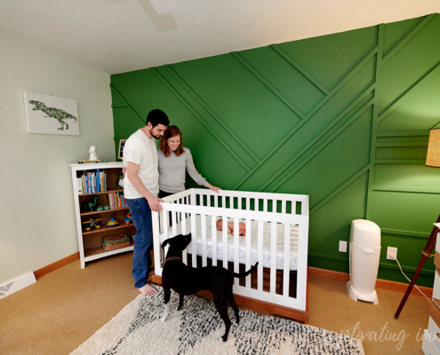 parents look on baby in crib