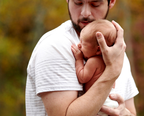 dad holds newborn