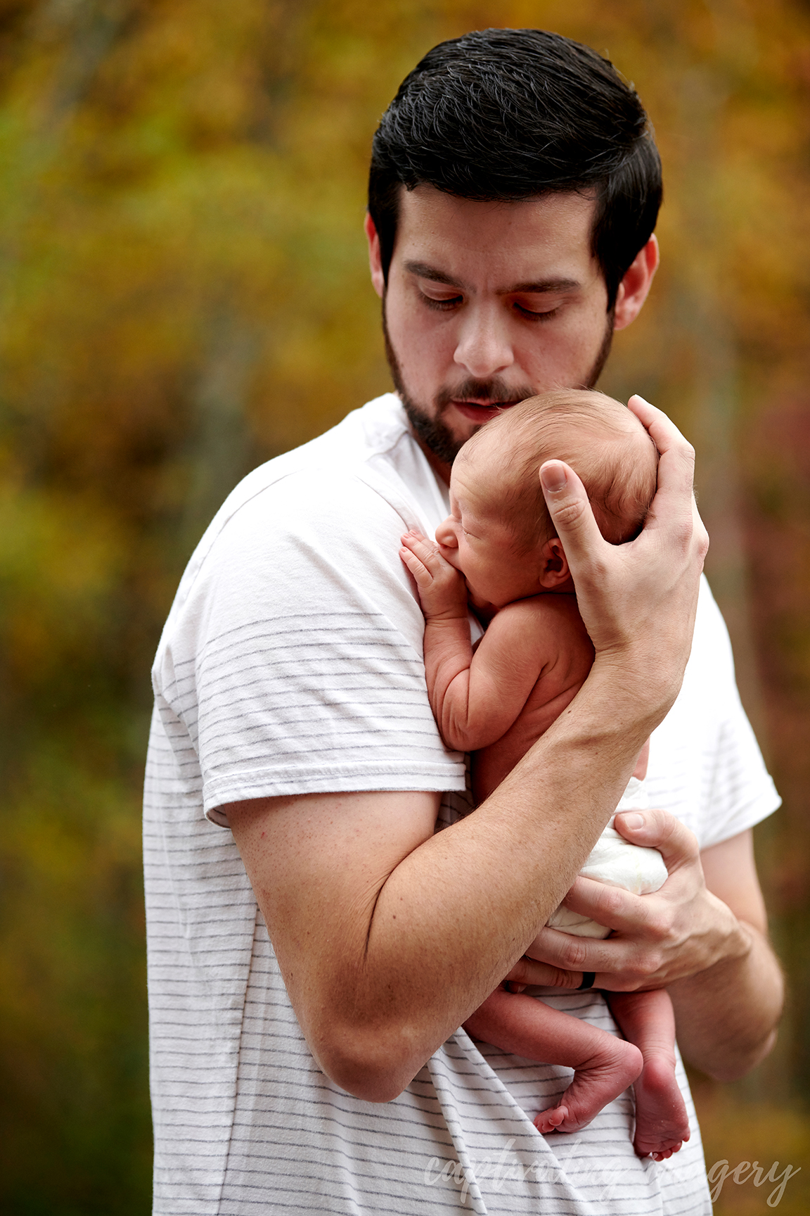 dad holds newborn