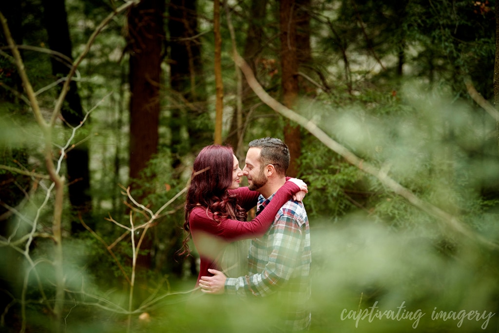 couple gazes at one another in forest