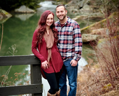 couple standing by creek
