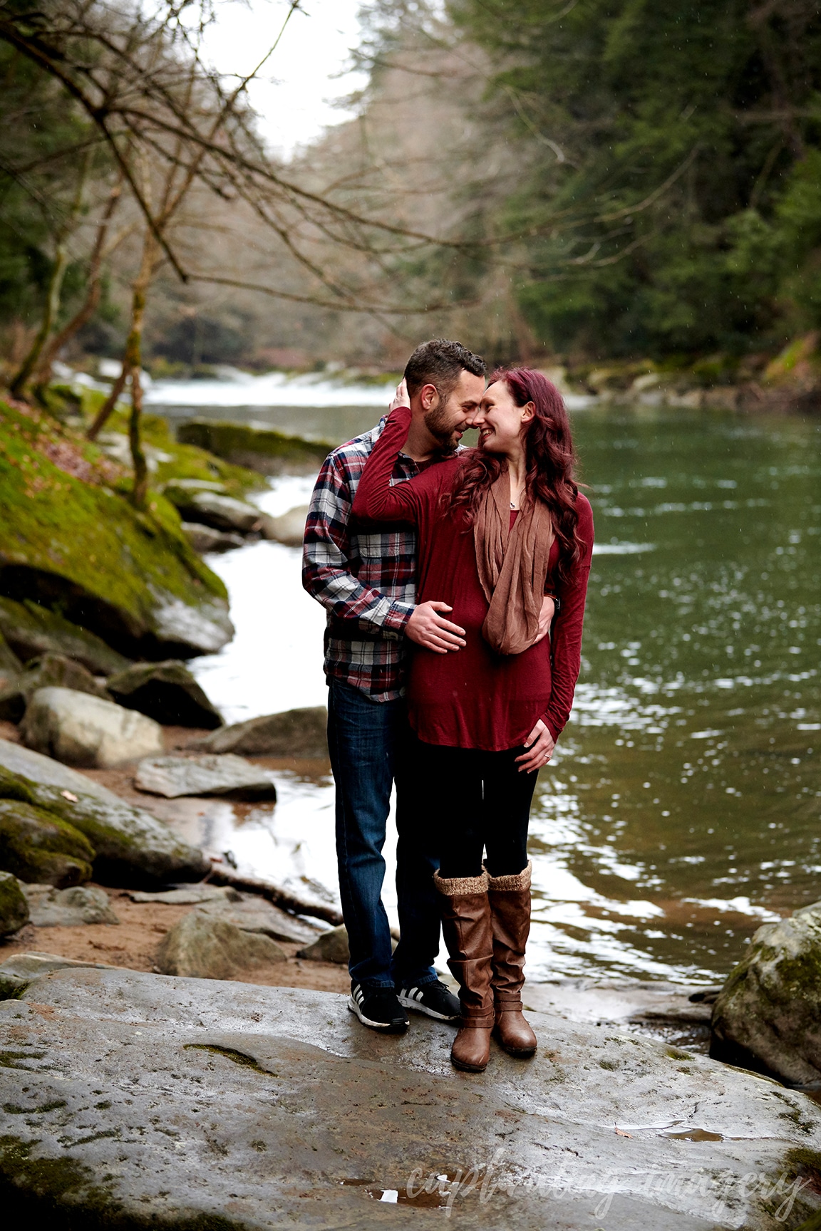 couple stands by creek