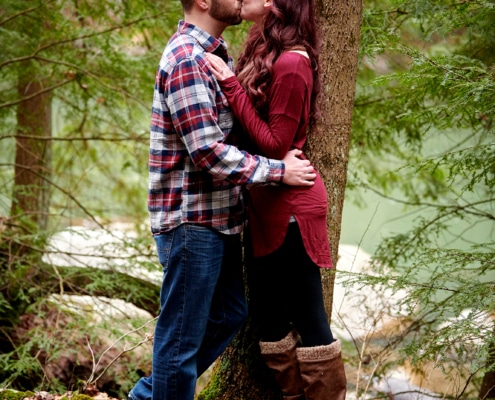 couple kissing in forest