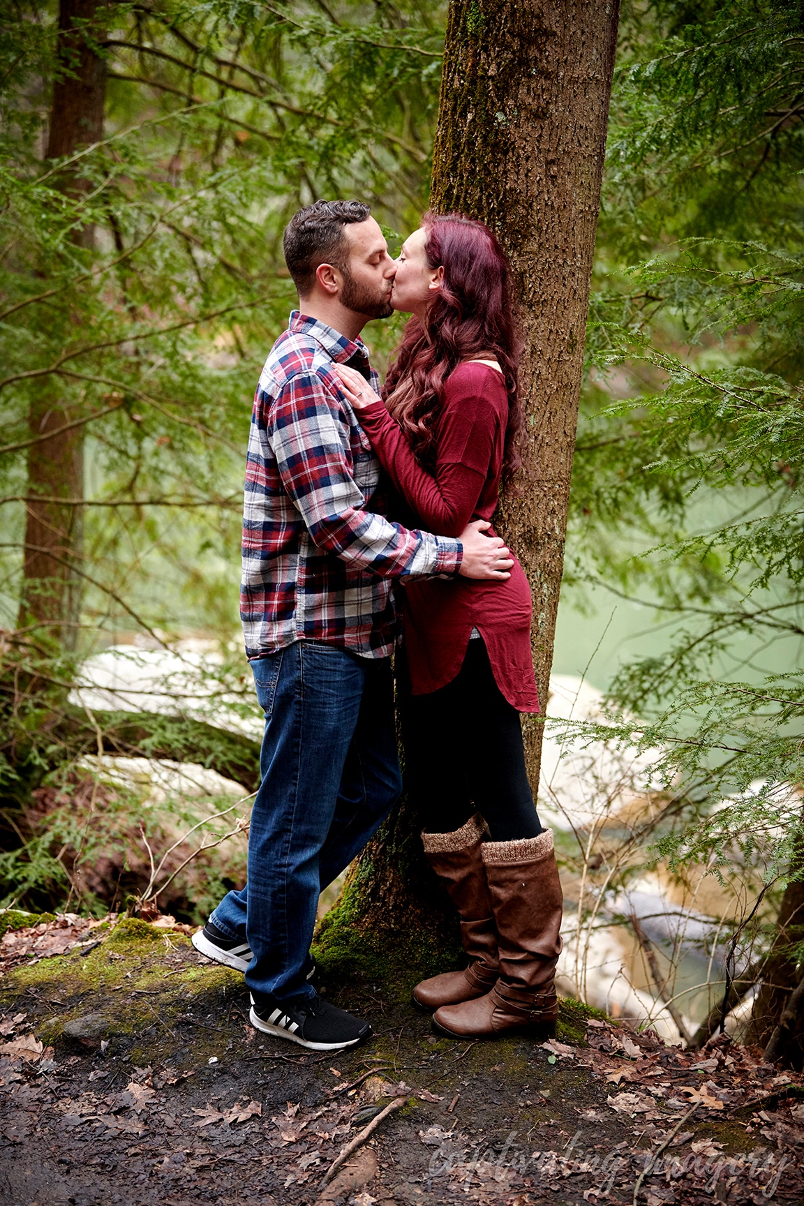 couple kissing in forest