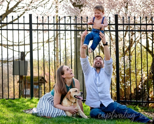 dad tossing laughing boy in air