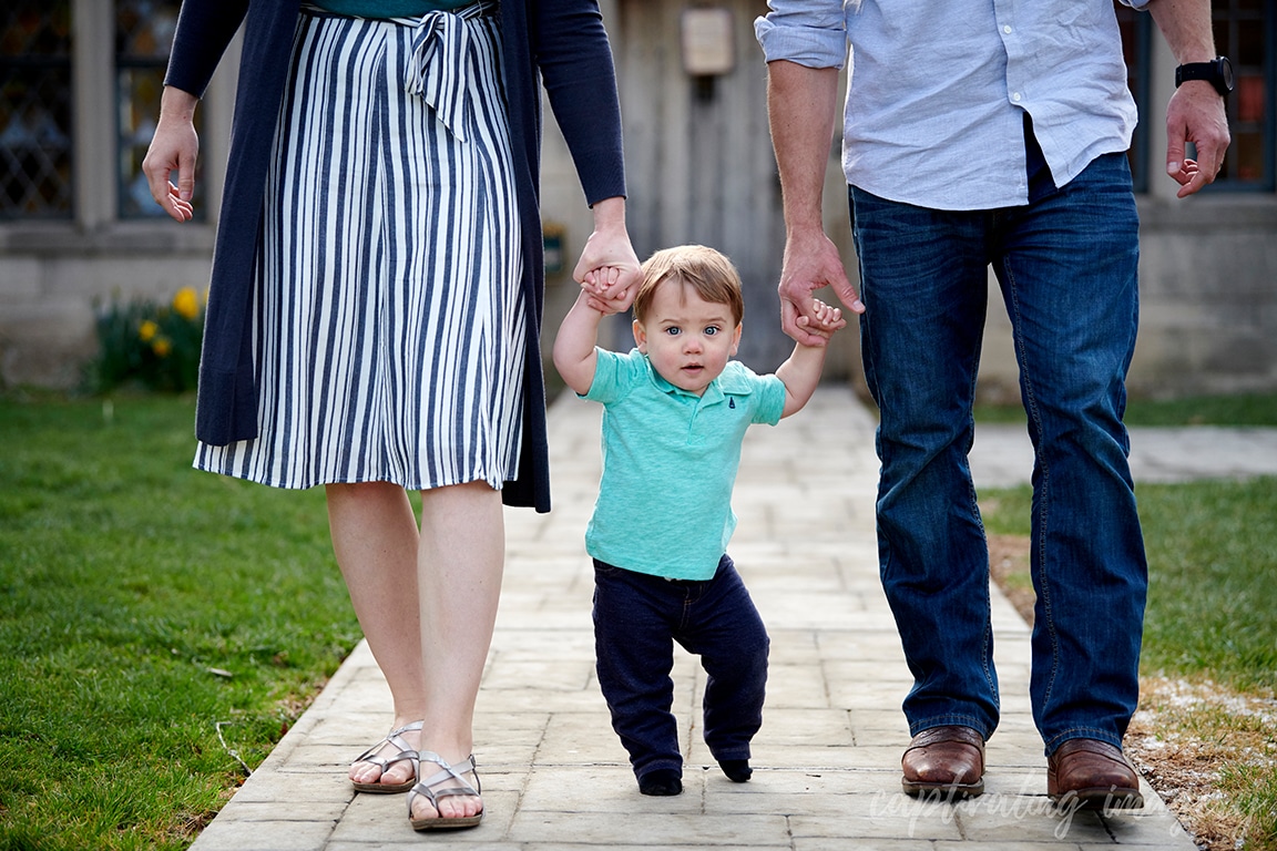 boy walking between parents