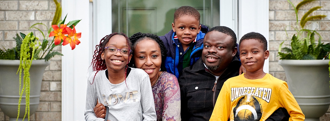 family portrait in front of house