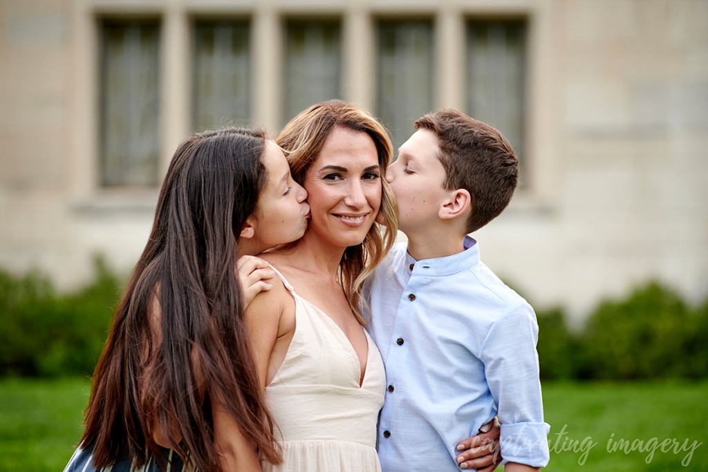children kiss mom's face