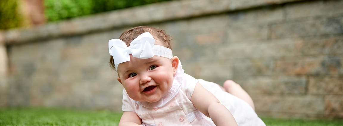 baby girl tummy time on grass