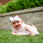 baby girl tummy time on grass