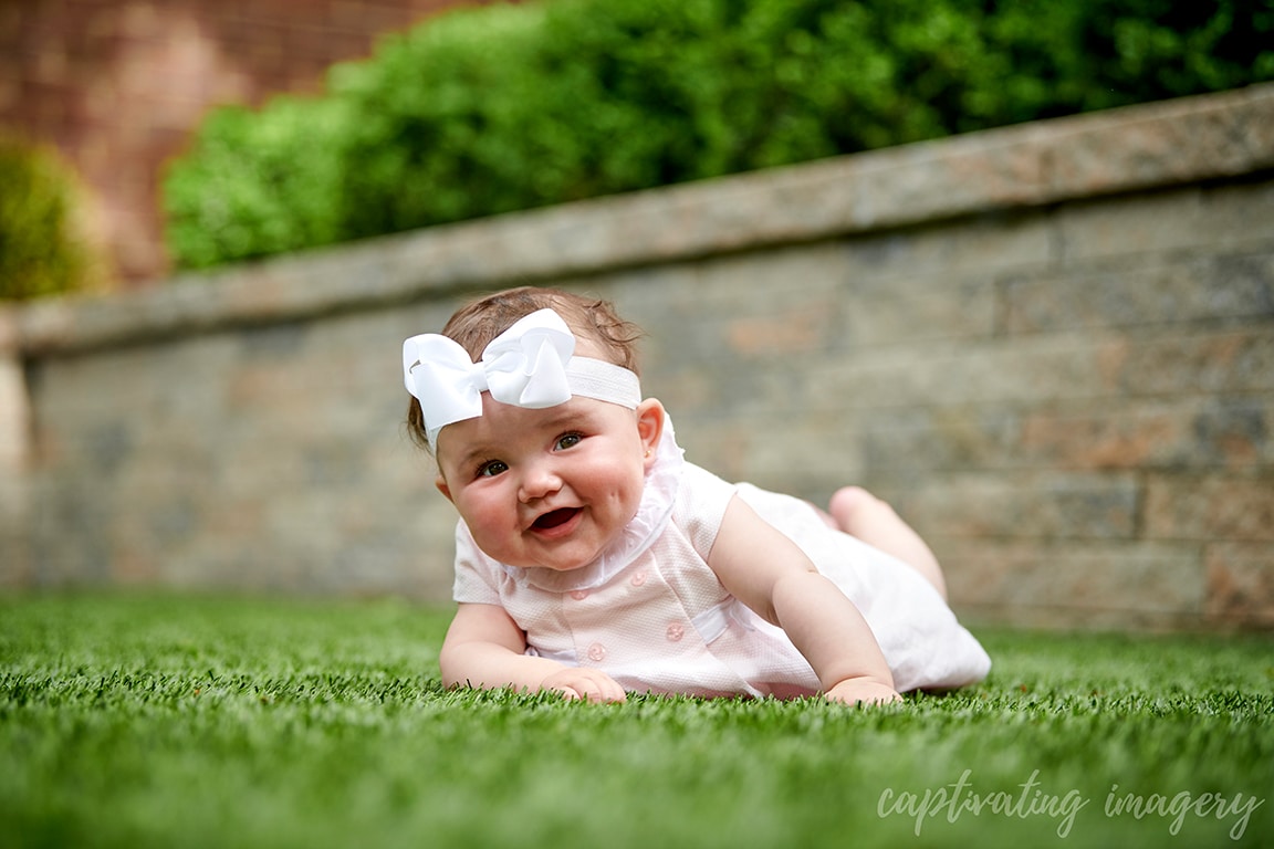 baby girl tummy time on grass