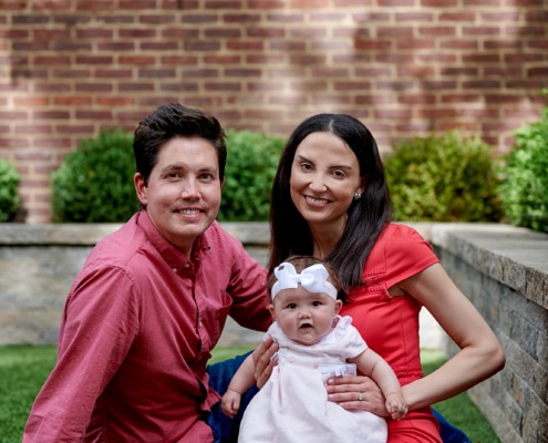 mom, dad, and baby outside