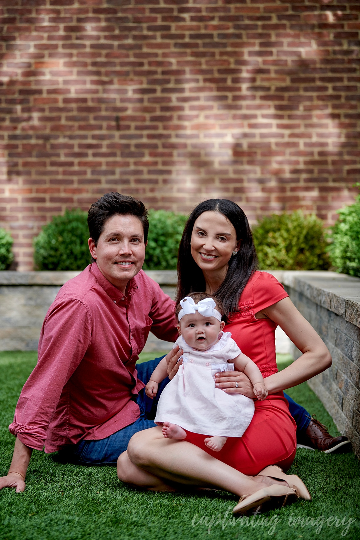 mom, dad, and baby outside